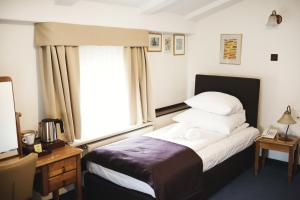 Łóżko lub łóżka w pokoju w obiekcie Hotel Eden