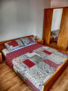 a bedroom with a bed with a red and white quilt at Sea View apartment, Panorama, Pools and beach, Sveti Vlas in Sveti Vlas