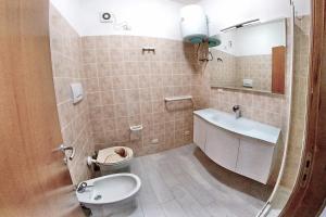 a bathroom with a sink and a toilet at Blu Baita in La Maddalena