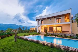 a house with a swimming pool in the yard at Nevras Resort Sapanca in Sapanca