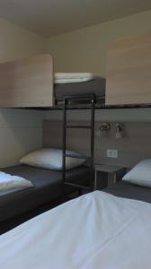 a room with two bunk beds and a bed at Mobile Home Cinzia in Pula