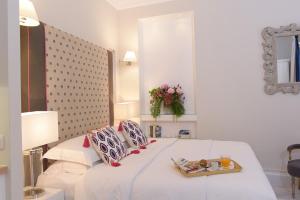 a bedroom with a bed with a tray of food on it at Merchant Liston Suite in Corfu