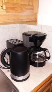 a coffee maker and a pot on a kitchen counter at Kilsborgs Gård - Lakehouse in Svanskog