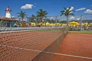 a tennis net on a tennis court with a lighthouse at Plaza Beach Holiday House in Prešov
