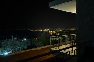 a view of a city at night from a balcony at Verga's Apartments in Kalamata