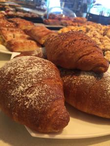 a plate of pastries and breads on a table at Bed & Breakfast Oltrepo in Casteggio