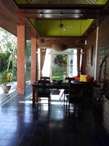 a dining room with a table and chairs at Villa Ketut Kartika in Ubud