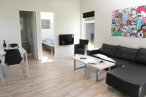 a living room with a couch and a table at Esbjerg Camping in Esbjerg