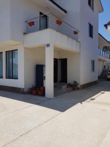 a white building with a balcony on top of it at Arena Dotro in Costinesti +33 photos