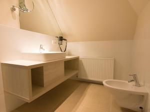 a bathroom with a sink and a mirror at Nordsee Domizil Schobüll in Husum +84 photos