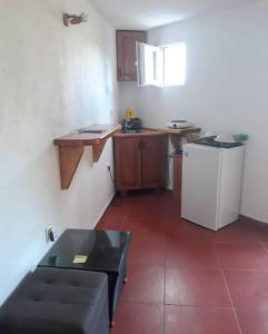 a small kitchen with a counter and a refrigerator at Draga`s rooms in Virpazar