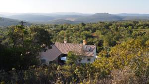 a house in the middle of a valley with mountains at B&B Casa Encantada in Boliqueime