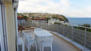 a balcony with a table and chairs and the ocean at Sunny House in Byala +50 photos