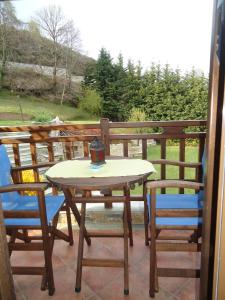 a table and two chairs on a patio with a view at Ktima Samanli in Kissós