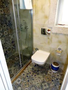 a bathroom with a toilet and a glass shower at Grand Alaçatı Butik Hotel in Alaçatı