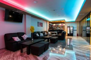 a lobby with couches and tables and a tv at SPA Kompleks Raiski Kat in Dimitrovgrad