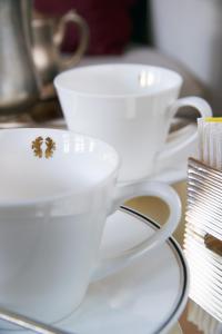 two white coffee cups sitting on a table at Hotel Palazzo Giovanelli e Gran Canal in Venice