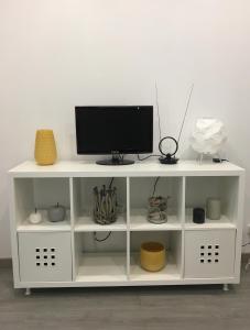 a white shelf with a tv on top of it at New Luxury Apartment - Lisbon Center in Lisbon
