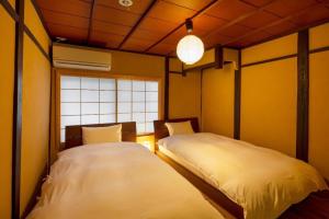 Un pat sau paturi într-o cameră la Kumashu an Machiya House