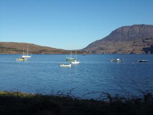 a group of boats floating on a large body of water at Caledonian Hotel 'A Bespoke Hotel’ in Ullapool