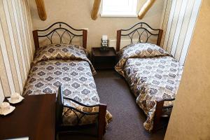 a bedroom with two beds and a table and a desk at Buožinta in Buožėnai