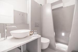 a bathroom with a sink, toilet and bathtub at Agave Santorini Design Boutique Hotel in Imerovigli
