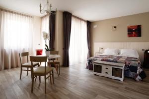 a bedroom with a bed and a table and chairs at Villa Poggio Bardolino in Bardolino +72 photos