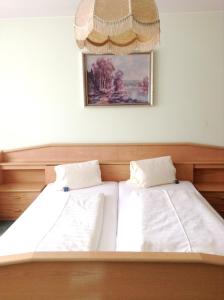 a bedroom with two beds and a picture on the wall at Hotel Garni in Bad Schallerbach