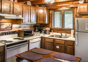 a kitchen with wooden cabinets and a white refrigerator at Sequoyah in Cartertown