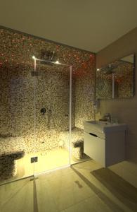 a bathroom with a glass shower with a sink and a shower at Nidos Namai in Nida