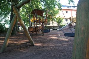 a group of swings in a park with trees at ZirkelsteinResort gGmbH in Schöna