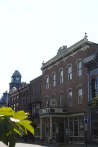 a brick building with a clock tower on a street at Hotel Millersburg in Millersburg