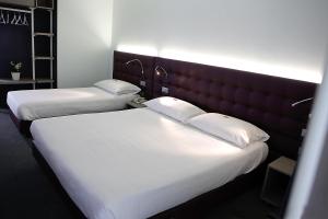 Posteľ alebo postele v izbe v ubytovaní Hotel Carnia