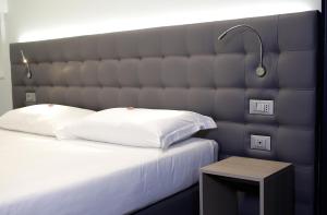 Posteľ alebo postele v izbe v ubytovaní Hotel Carnia