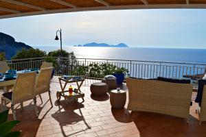 a patio with chairs and a table and the ocean at Maridea - Magia di Circe in Ponza +56 photos