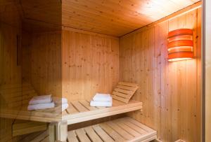 a wooden sauna with towels sitting in it at Fletcher Hotel-Restaurant Arion-Vlissingen in Vlissingen