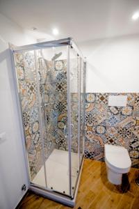 a bathroom with a shower and a toilet at Pandora in Porticello