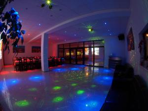 a room with a dance floor with green lights at Kancelaria in Szczecin