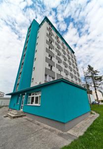 a large blue and white building with a blue building at Hotelak Martinov in Ostrava