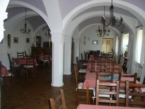 a dining room with tables and chairs in a building at Landhaus Hohenroda in Hohenroda