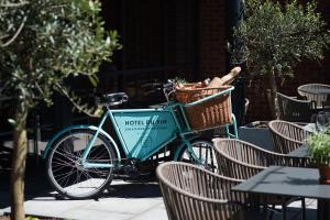 
a bicycle parked in front of a wooden bench at Hotel Du Vin Stratford in Stratford-upon-Avon
