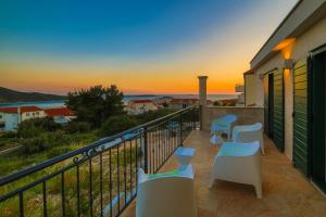 a balcony with chairs and a view of the ocean at Villa Eni in Primošten