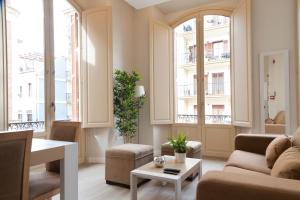 un soggiorno con divano e tavolo di Apartamentos Pinar Malaga Centro a Málaga