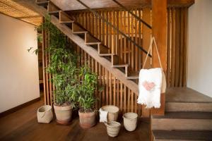 a wooden staircase leading up to a room with a bunch of plants at Pousada Literária de Paraty in Paraty