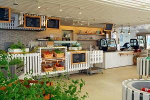 a fast food restaurant with a counter with vegetables at Camping Bunculuka in Baška +24 photos