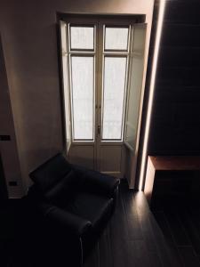 a living room with a couch and a window at Loft Acaja in Fossano