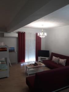 a living room with a couch and a coffee table at Filoxenia Apartments in Skala Sotiros