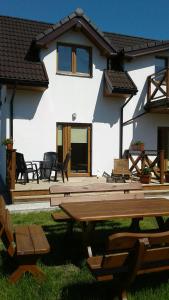 a wooden deck in front of a house at Dom nad morzem Sosenka in Mielenko