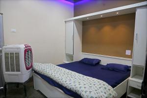 a bedroom with a bed and a air conditioner at Hotel Siddharth in Tanakpur