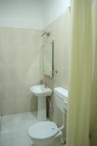 a bathroom with a toilet and a sink at Hotel Siddharth in Tanakpur +28 photos
